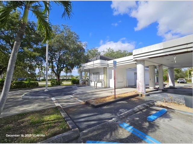 Broward County Property Appraiser exterior photograph of the former drive-through building at 8579 Pines Boulevard